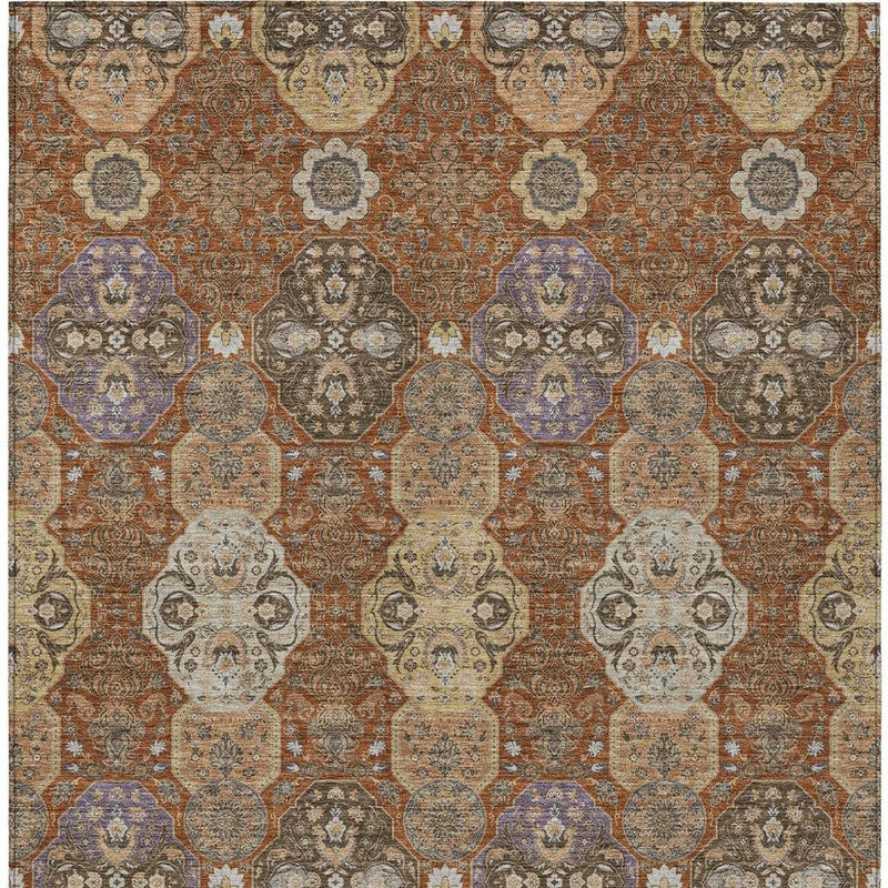 Orange copper medallion floral area rug, tight close-up of repeating geometric motifs.