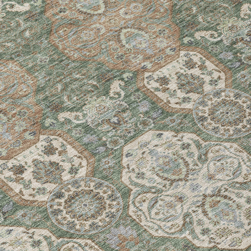 Green area rug close-up of cream and tan floral medallions on textured weave