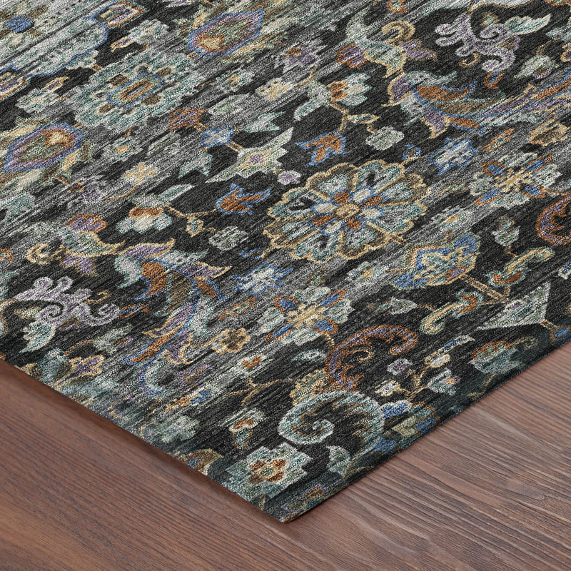 Corner view of dark charcoal area rug with multicolor floral medallion pattern