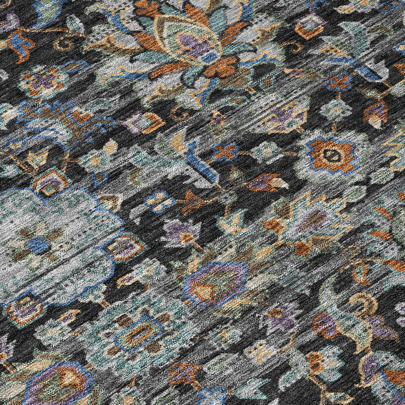 Close-up of dark charcoal area rug showing intricate floral medallion pattern