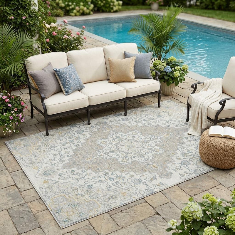 Outdoor-ready medallion area rug with ornate pattern in ivory, taupe, and blue
