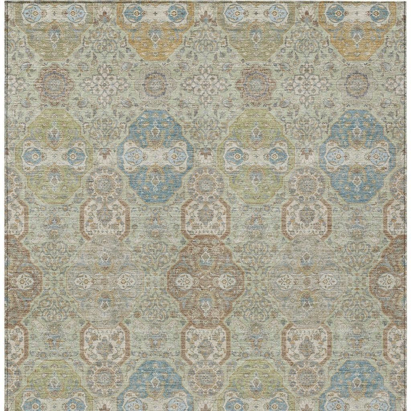 Rectangular sage and green floral medallion rug with blue accents and distressed finish