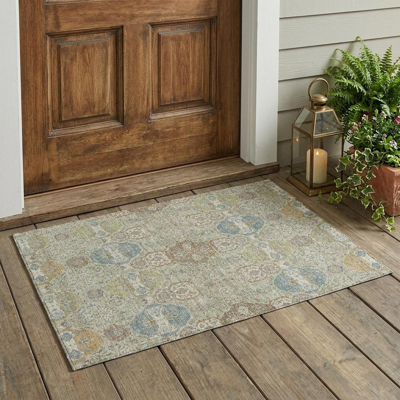 Sage and green floral area rug with medallion pattern laid on wood porch floor