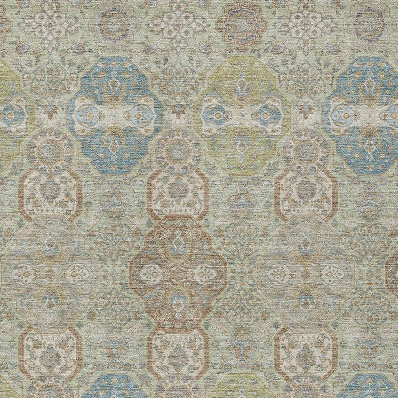 Close-up of sage, green, and blue floral medallion rug pattern on light background