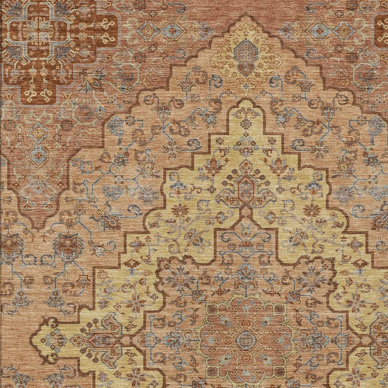 Copper and gold medallion area rug with blue scrollwork, centered motif.