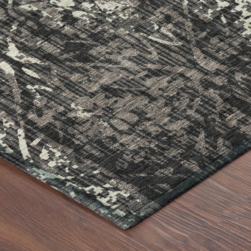 Damask area rug corner showing dark charcoal base with light abstract damask lines.