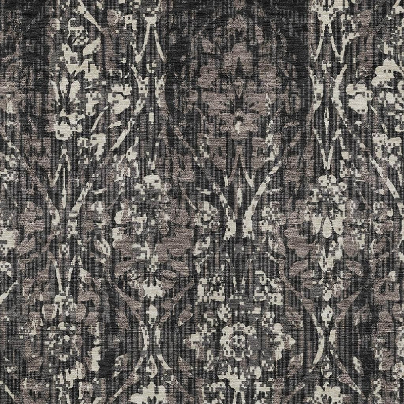 Damask rug pattern detail in dark charcoal with scattered cream ornamental shapes.