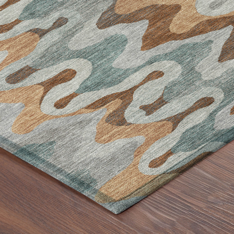 Abstract area rug corner detail with gray pile and wavy pattern in teal and rust tones