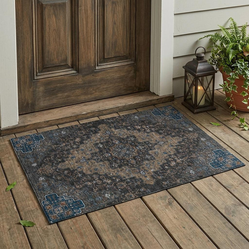 Ornate medallion area rug in dark charcoal with blue and tan accents, flat weave