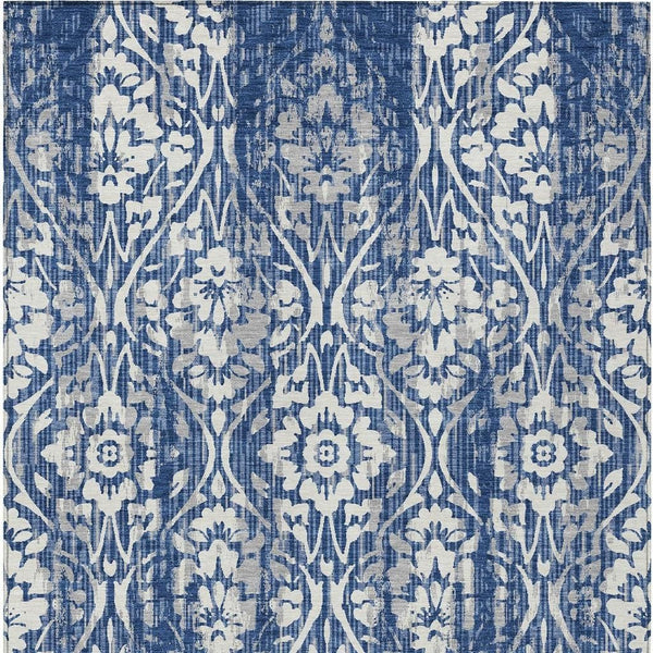 Blue damask area rug with repeating floral lattice pattern
