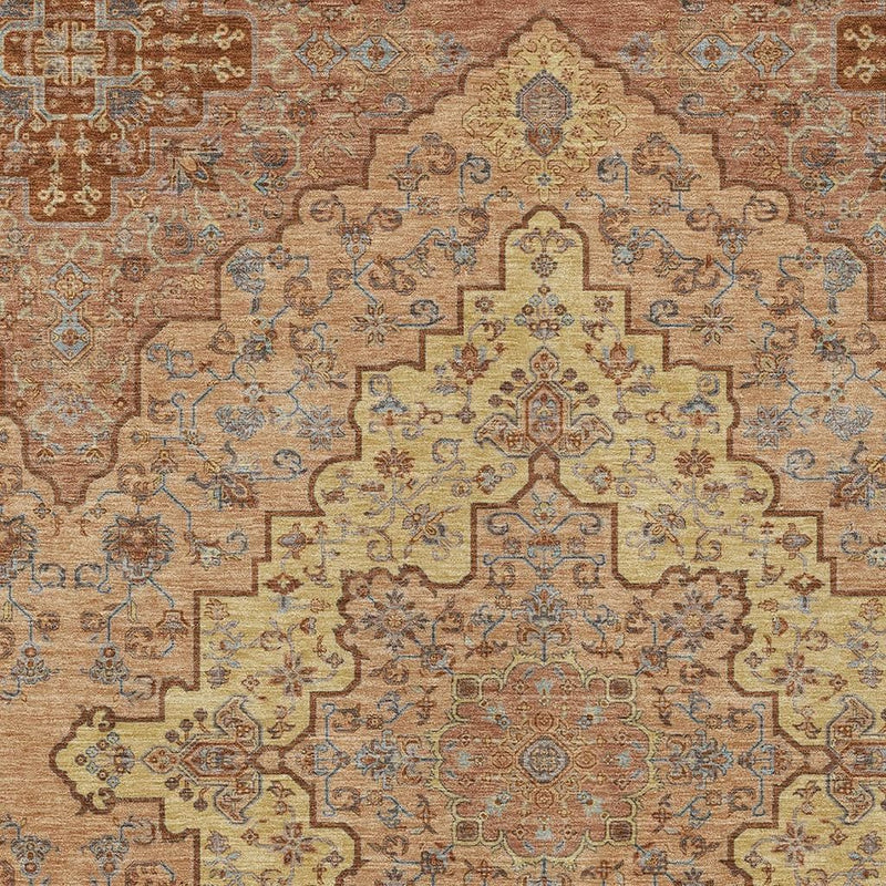 Close-up washable area rug featuring copper medallion motif with blue ornamental details.