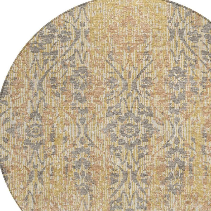 Round damask area rug close-up, gold ground with repeating gray ornamental medallions