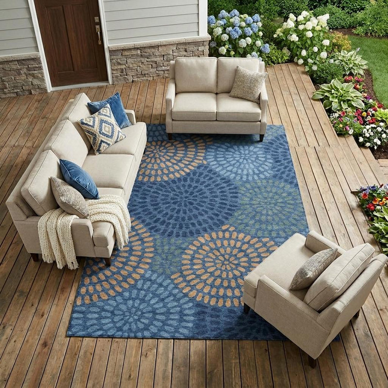 Blue geometric area rug with large circular medallions in orange and gray