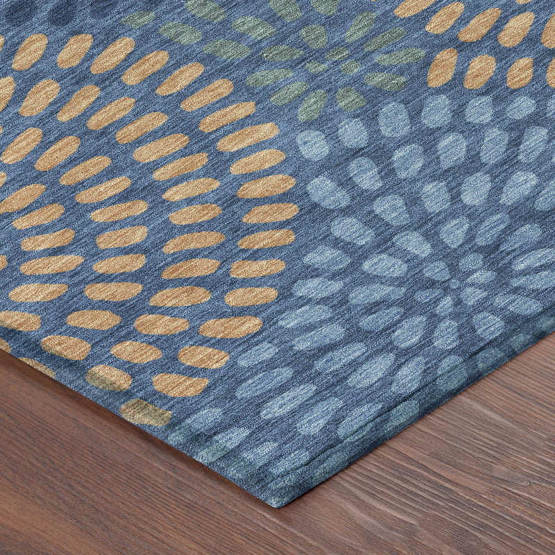 Blue geometric area rug corner with orange dash dots and green accent shapes