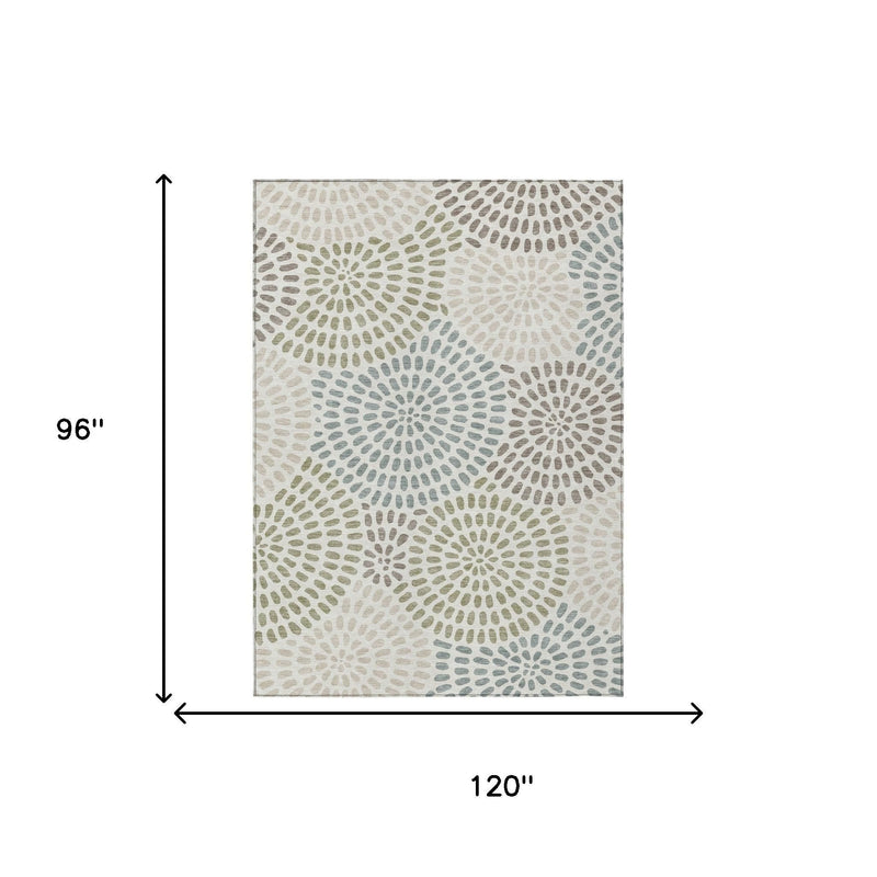 Ivory area rug with sage and dusty blue circular geometric bursts, rectangular