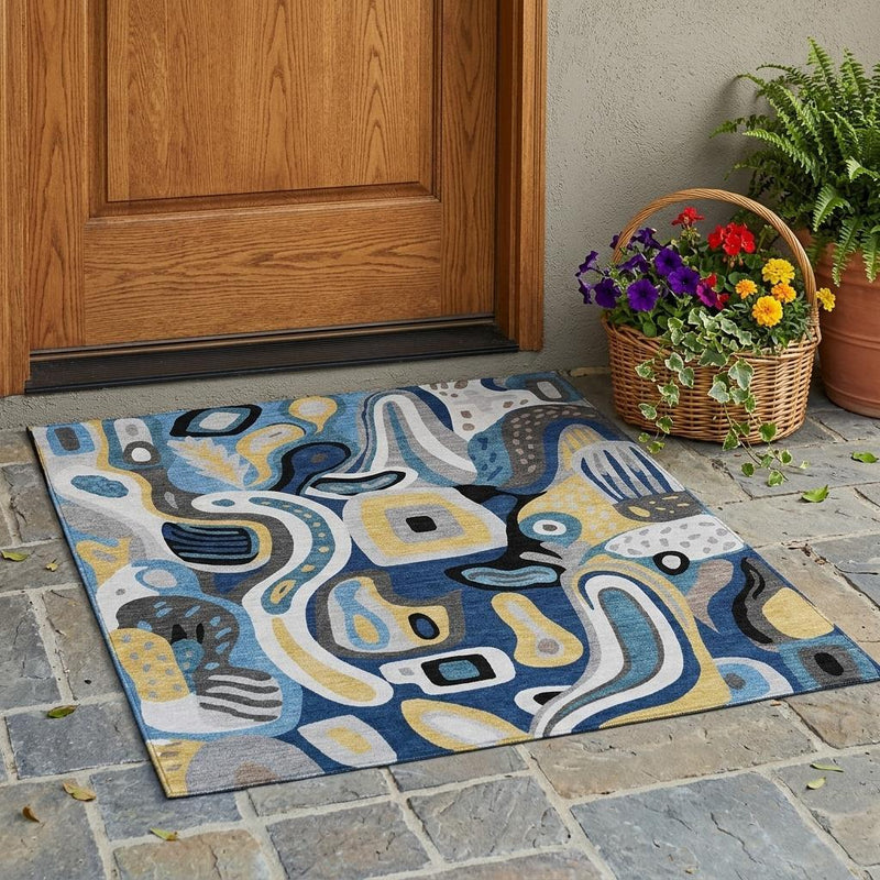 Abstract area rug outdoors with blue and navy pattern, yellow accents, and light gray base