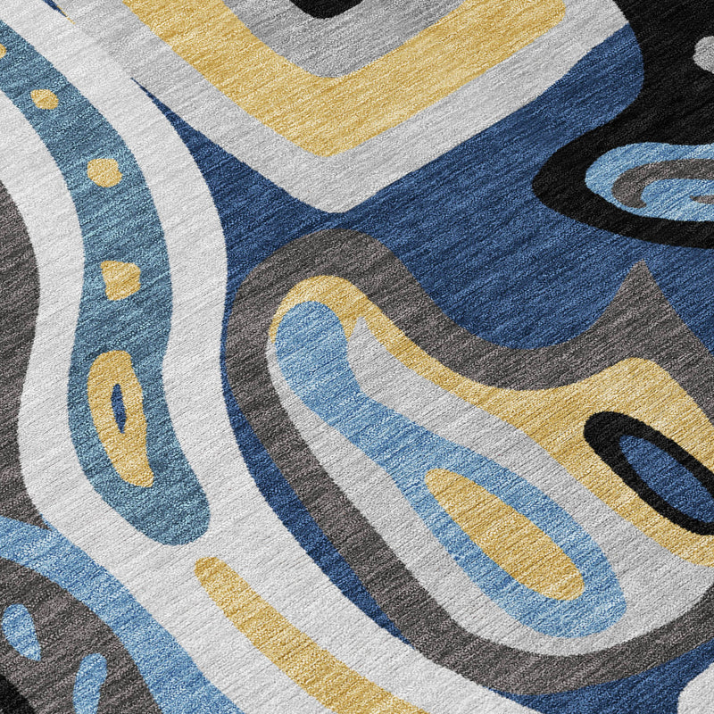 Close-up of abstract rug pattern with blue, navy, gray, and yellow curved shapes
