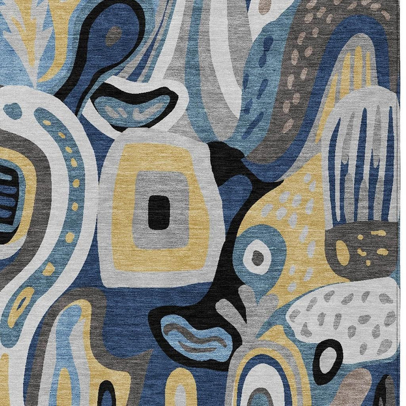 Close-up abstract rug design with blue and navy lines, gray textures, and yellow blocks
