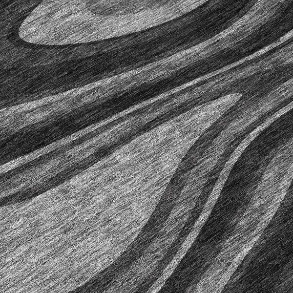 Abstract area rug with black and charcoal wavy stripe pattern