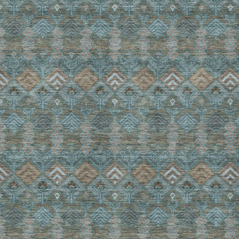 Teal blue geometric area rug close-up with repeating diamond shapes in tan
