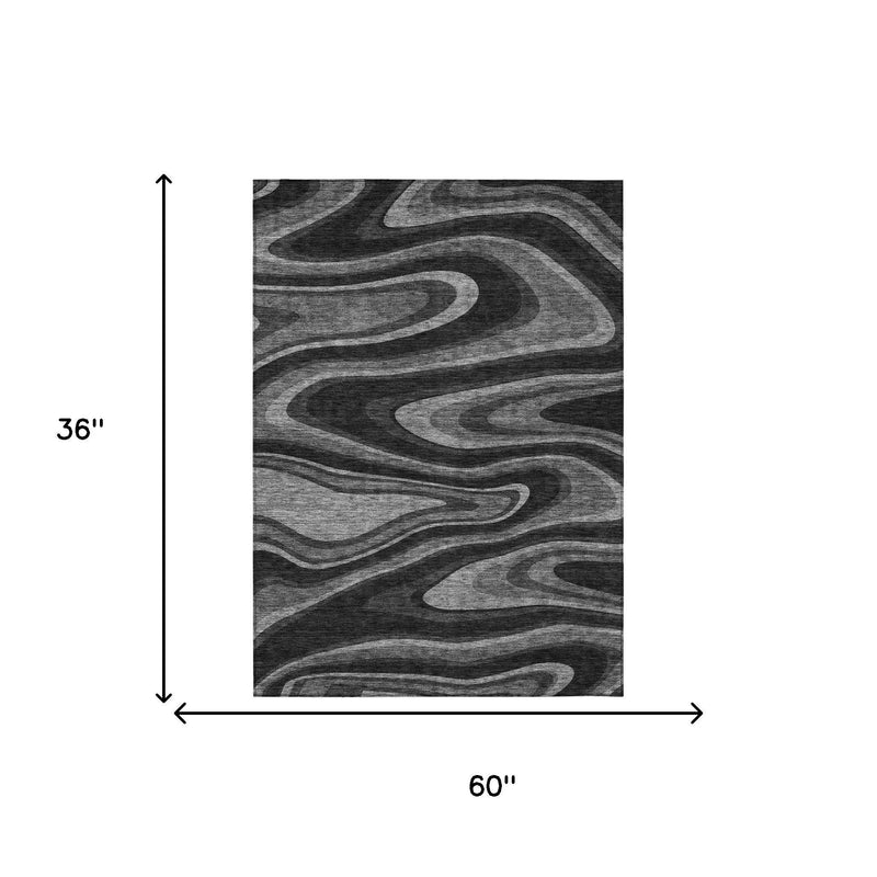 Black and charcoal abstract rug with wavy swirl design, 60 in x 36 in