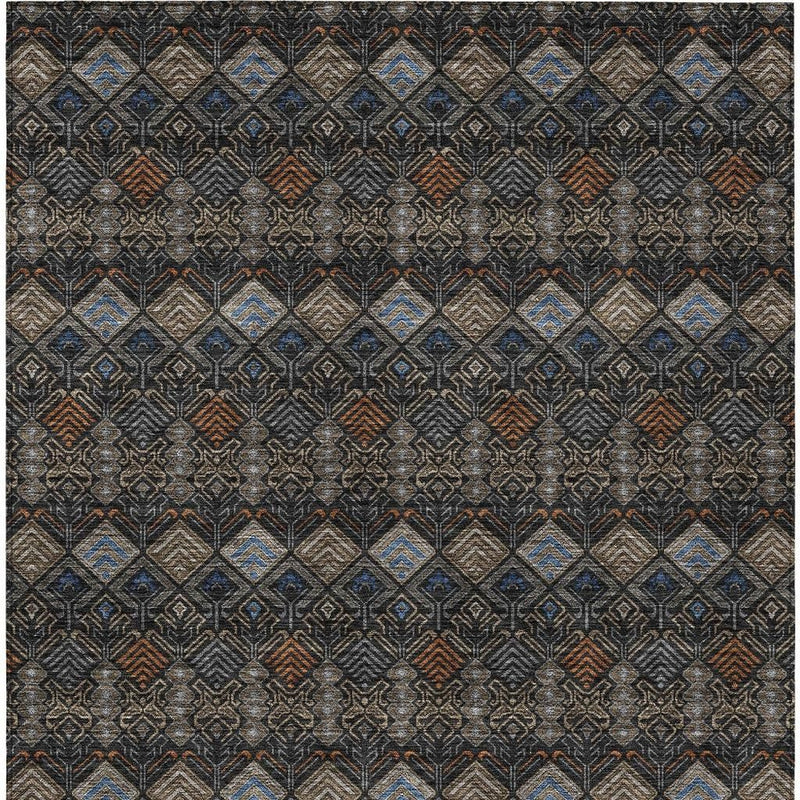 Geometric area rug with repeating diamond pattern in dark charcoal, tan, blue, and rust