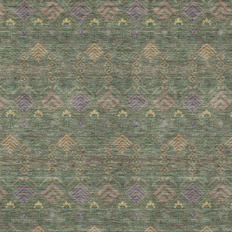 Close-up of green and olive area rug with repeating geometric diamond and zigzag pattern
