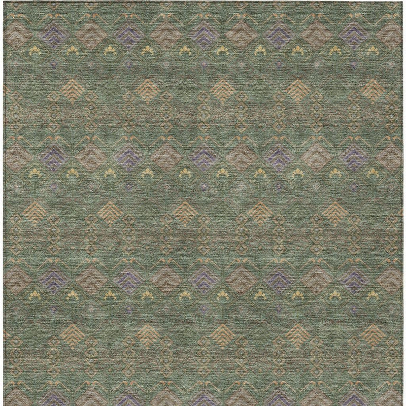 Green and olive area rug featuring repeating geometric icons in muted orange and purple