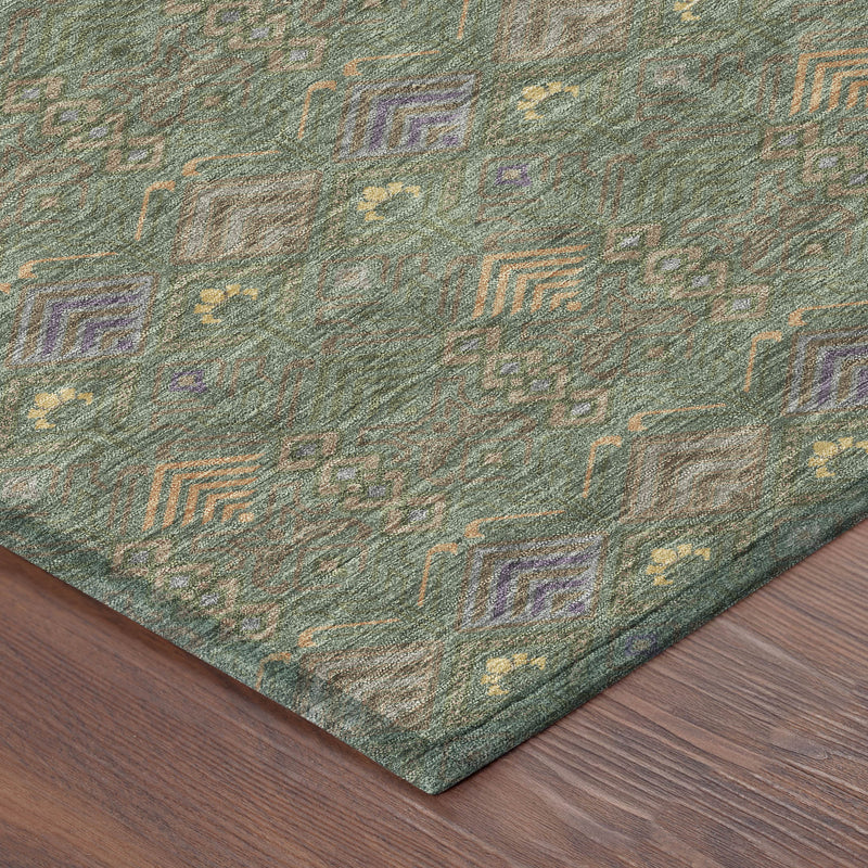 Corner detail of green and olive geometric patterned area rug with textured weave