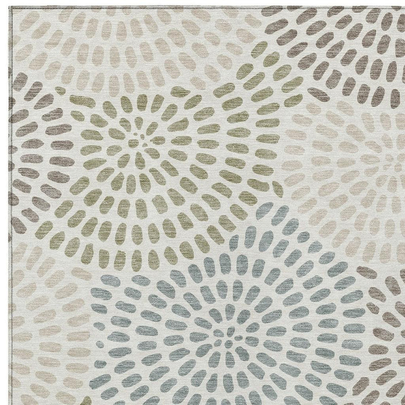 Ivory and sage geometric area rug with large circular dotburst motifs, close-up