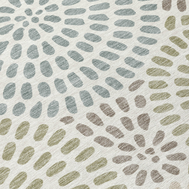Close-up of ivory and sage geometric area rug texture with circular dotburst motifs