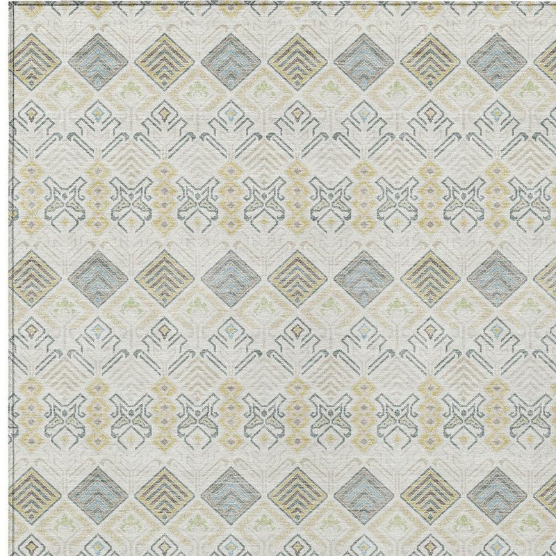 Area rug with ivory ground and repeating geometric shapes in blue, green, and wheat tones