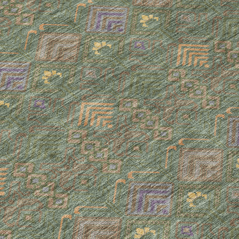 Green and olive geometric area rug close-up with multicolor diamond and zigzag pattern