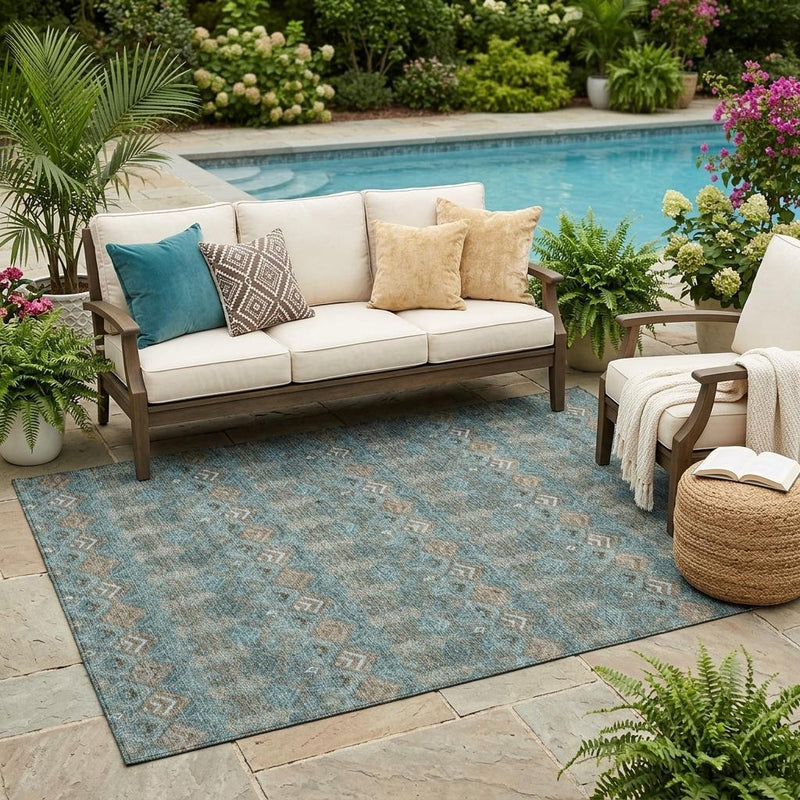 Teal blue geometric area rug on patio, diamond and zigzag pattern in beige and charcoal