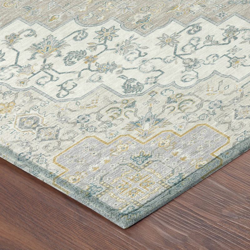 Close-up of round rug corner showing blue and ivory medallion motifs with taupe accents