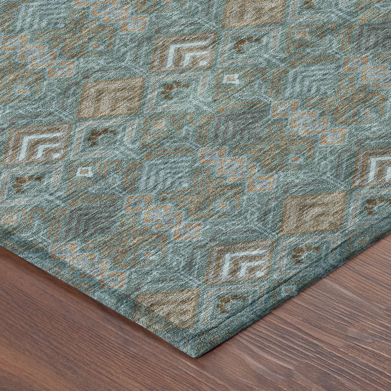 Teal geometric area rug corner with diamond motifs in tan and dark gray