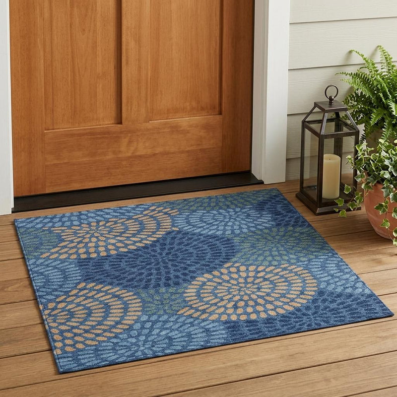 Navy blue indoor area rug with large circular daisy motifs in tan and light green