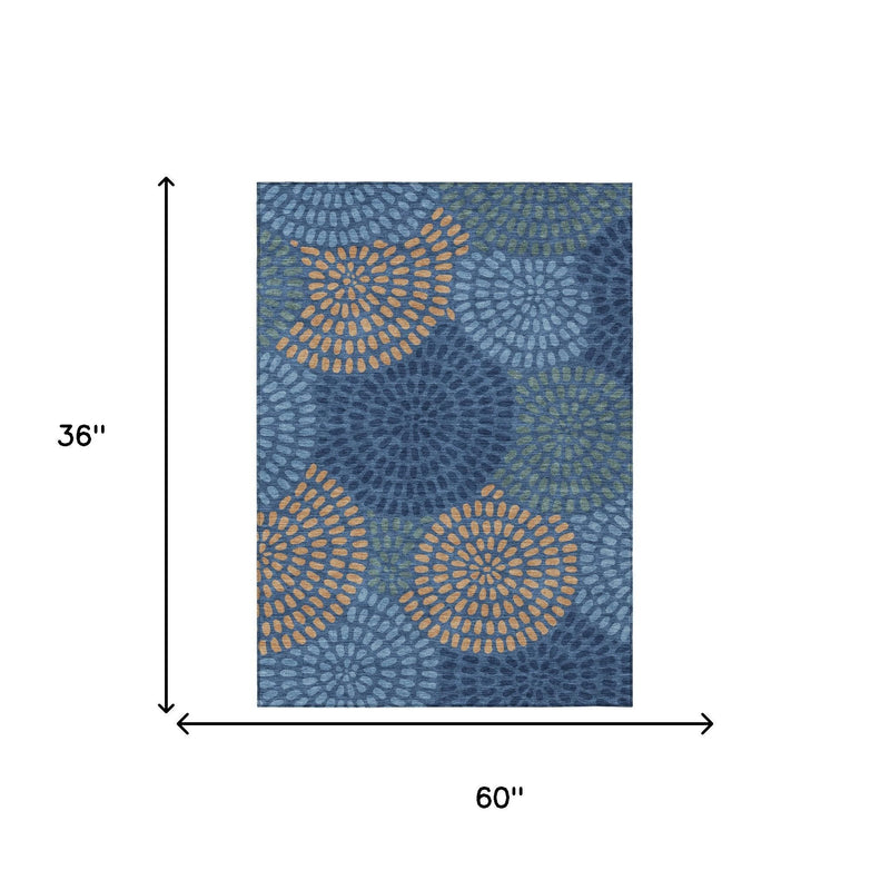Navy blue area rug, 36x60 in, with circular daisy pattern in tan and light green