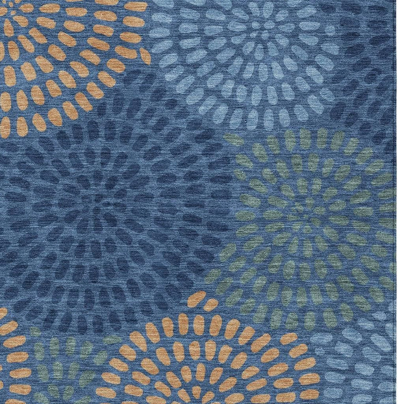 Close-up of navy blue area rug with radial dot circles in tan and light green