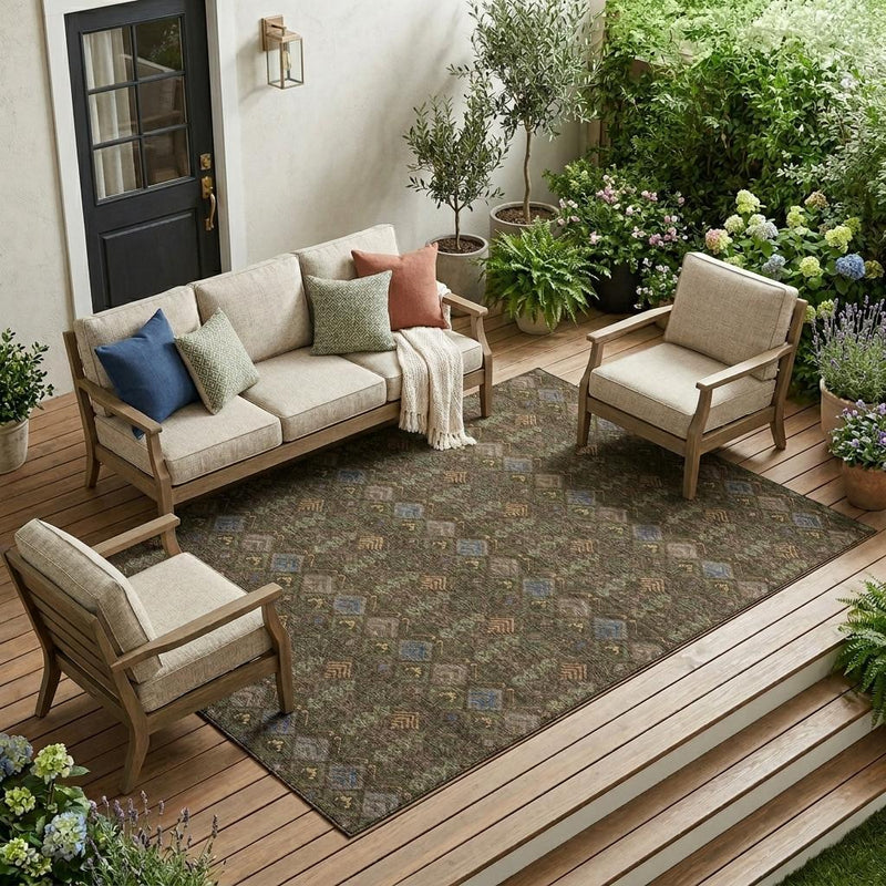 Geometric area rug with brown, green, and blue diamonds and chevrons on patio