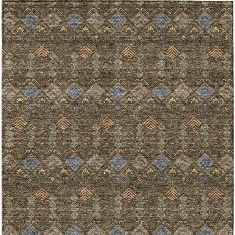 Geometric area rug close-up with diamond rows in blue, tan, and rust on olive brown