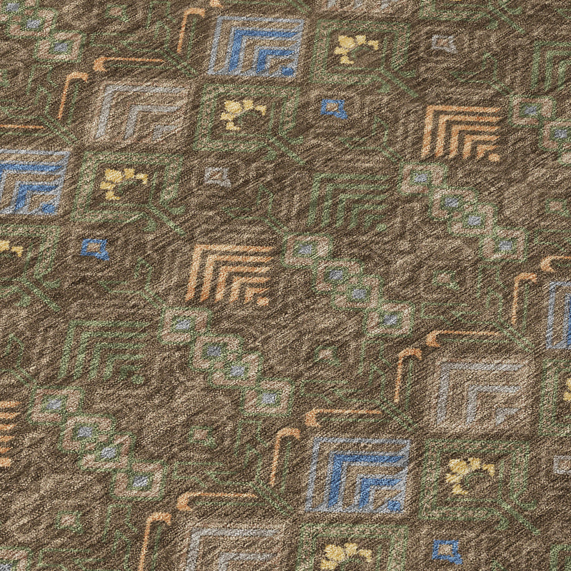 Geometric area rug close-up with scattered diamonds in blue and gold on brown-green