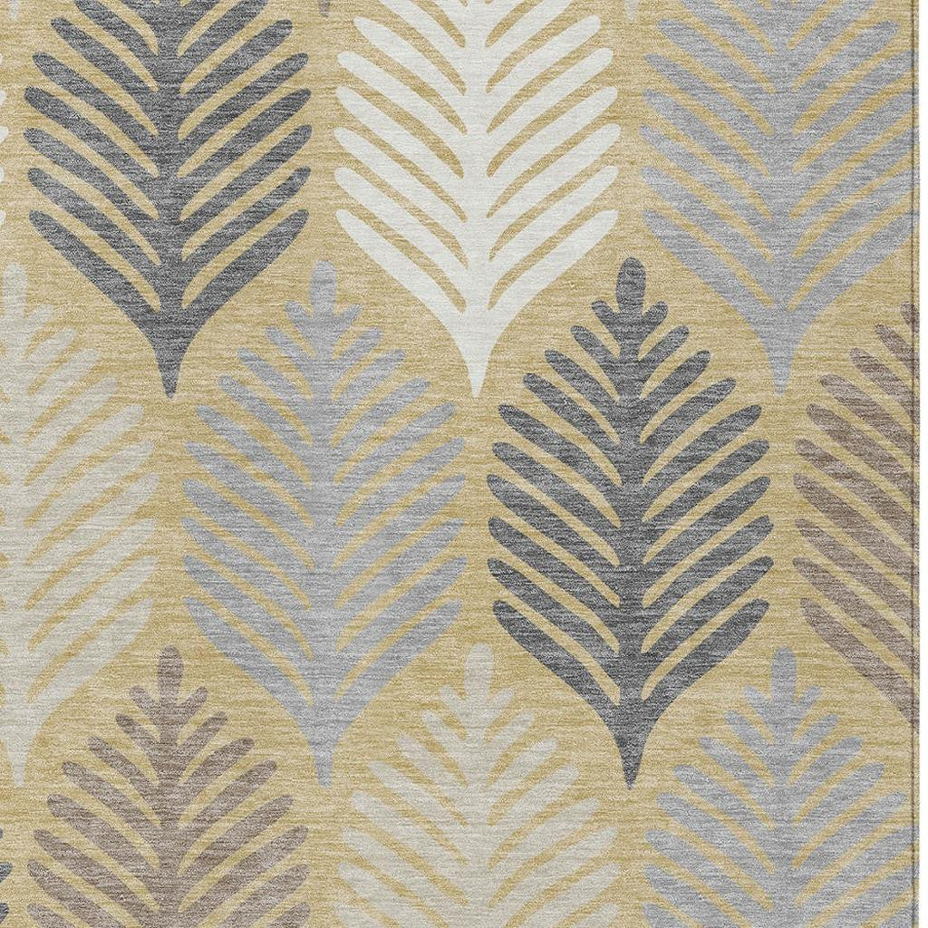 Ivory and gold leaf motif area rug with gray printed pattern, tight detail view