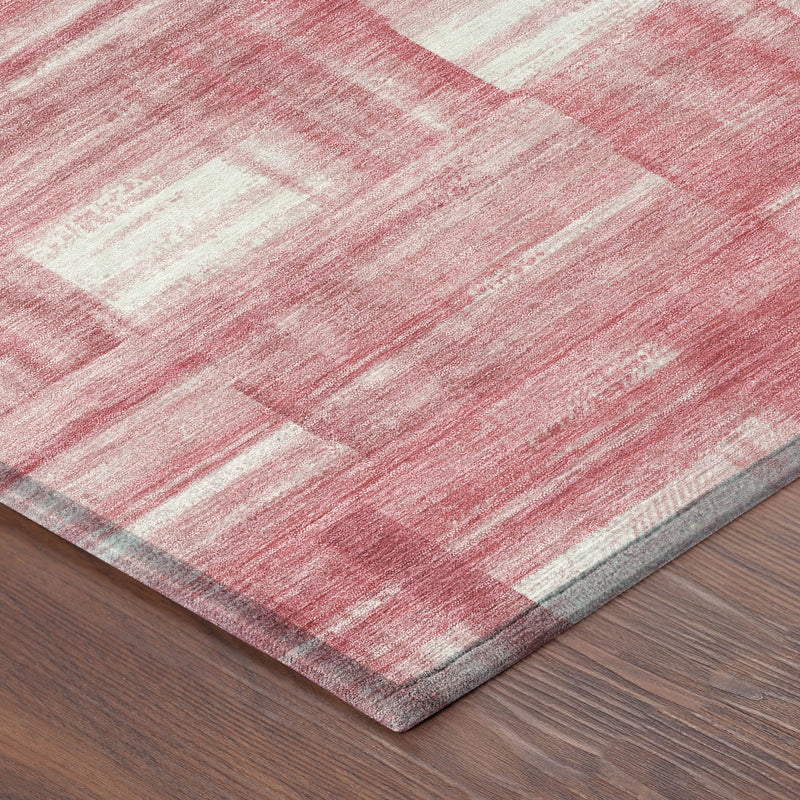 Area rug with pink and ivory striped distressed pattern, textured low-pile edge.