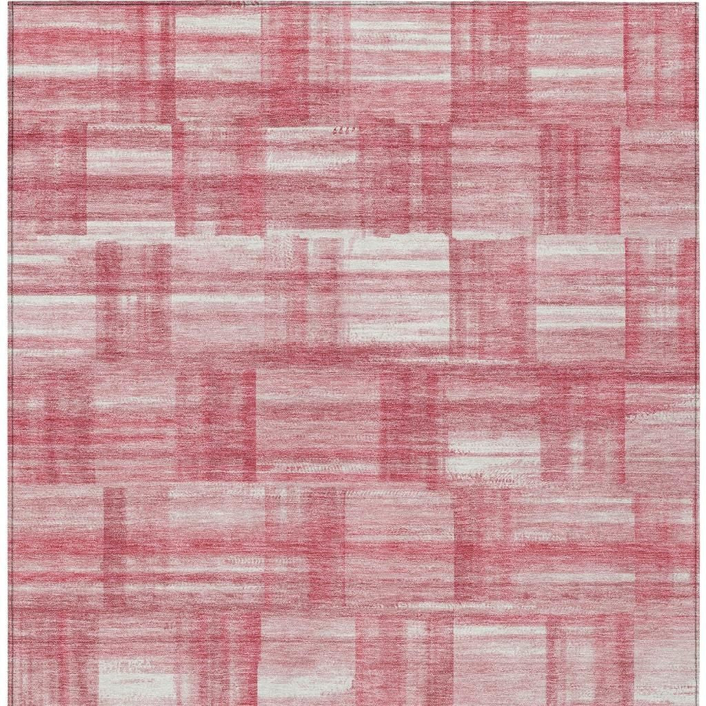 Area rug featuring pink and ivory patchwork stripe pattern with distressed low-pile.