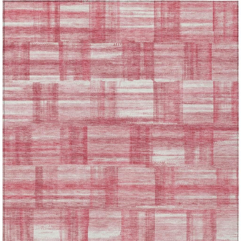 Area rug featuring pink and ivory patchwork stripe pattern with distressed low-pile.