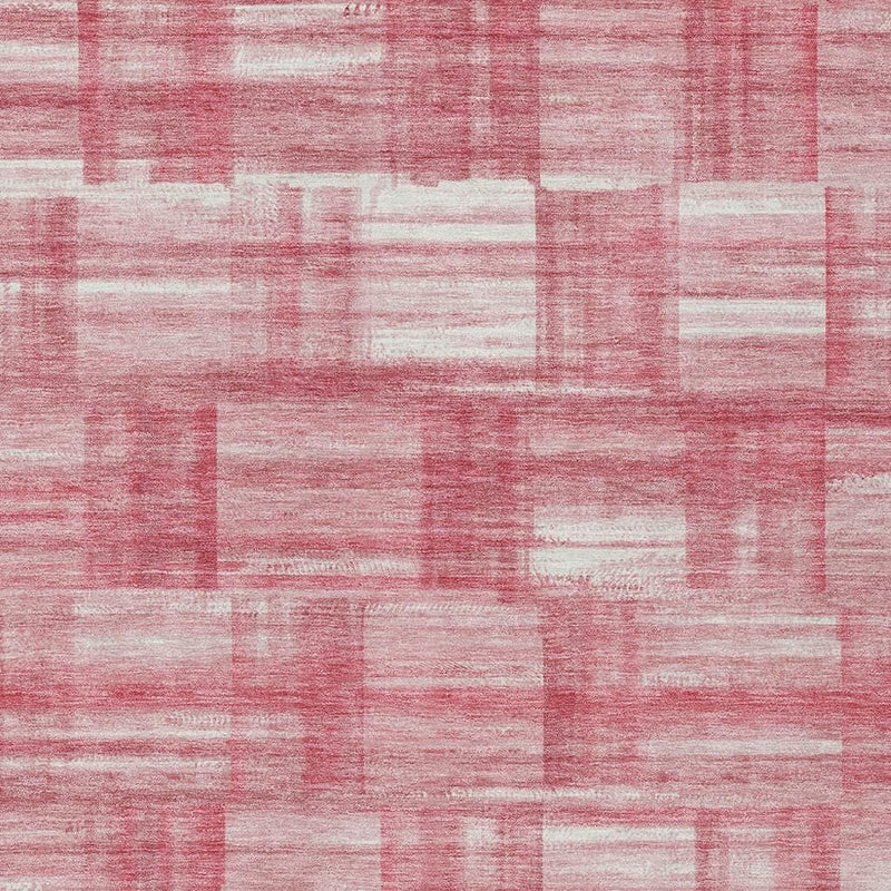 Area rug close-up of pink and ivory square block stripes with distressed texture.