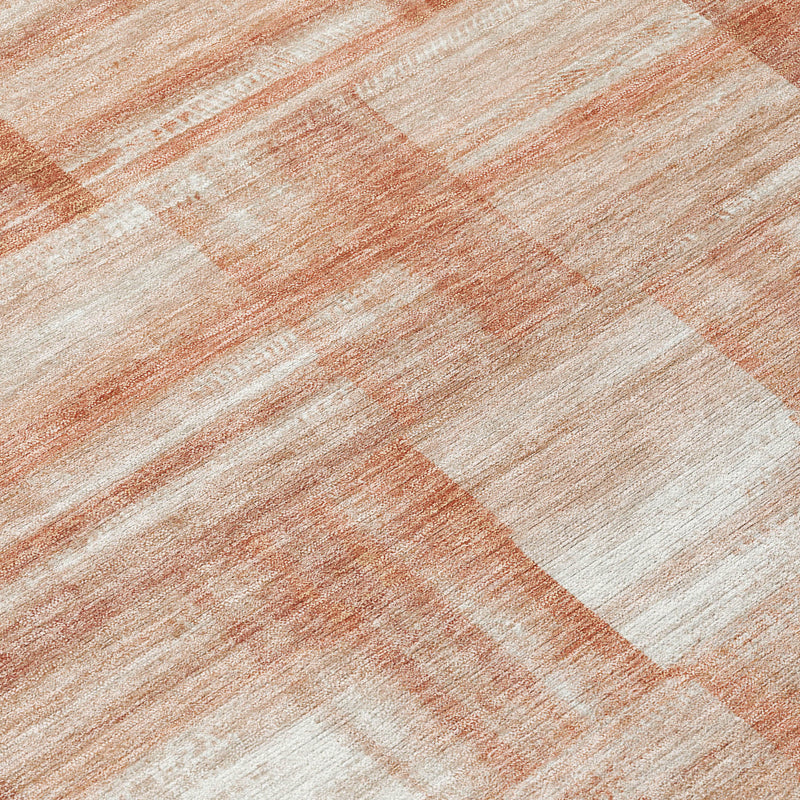 Area rug close-up with copper-orange and cream diagonal stripe pattern