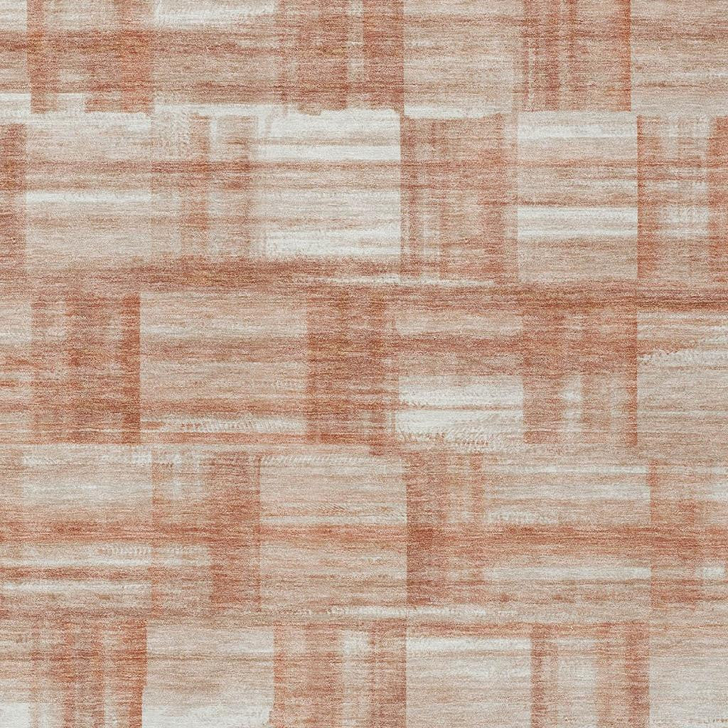 Textured area rug face with cream and copper-orange block pattern