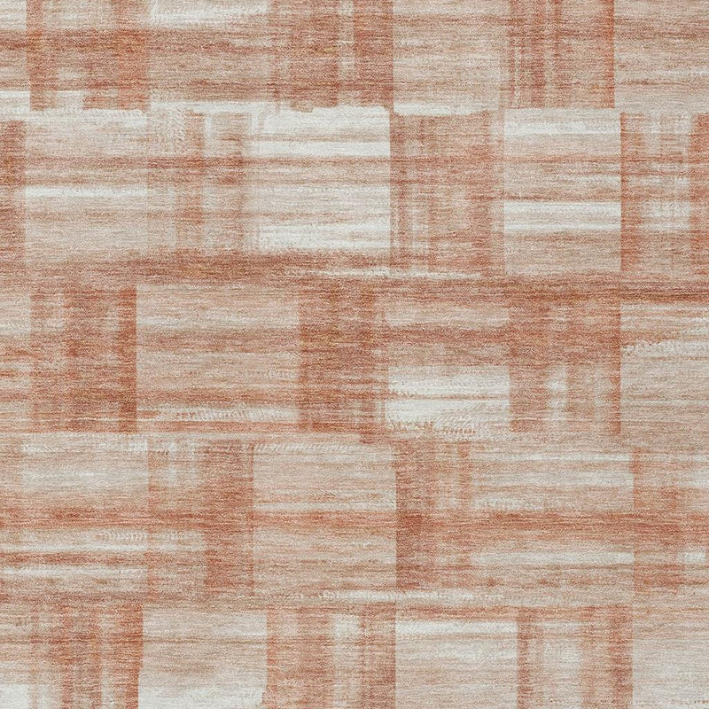 Textured area rug face with cream and copper-orange block pattern